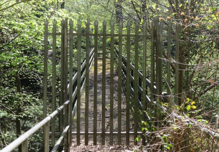 Metal gate blocking the way over a bridge